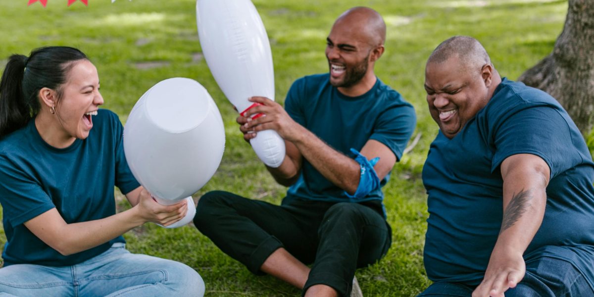 A group of colleagues enjoying a non-escape room team building activity outdoors, fostering continued connection and enjoyment.