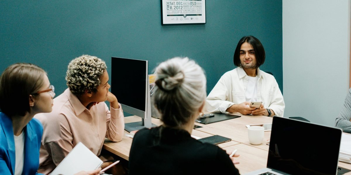 A team engaging in a debrief session, reflecting on their experience and discussing insights.